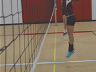 woman guarding volleyball net